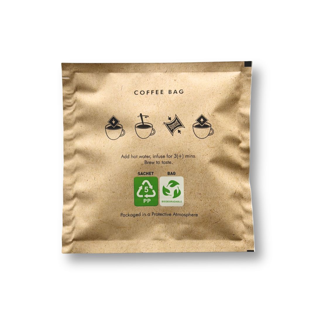 Kraft paper coffee bag with brewing instructions and recycling symbols on a white background